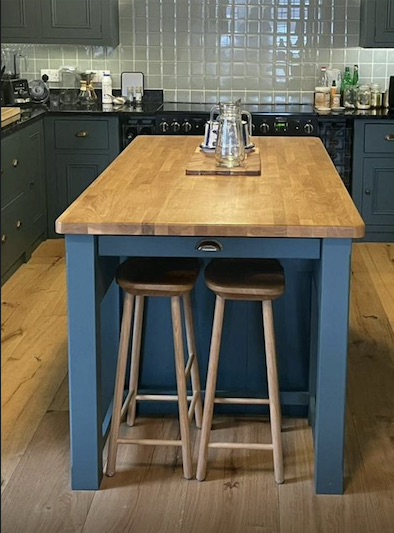 After - New kitchen island with oak worktop and bar stools